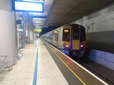 The Heathrow Express at Terminal 5 — the platform screen shows 'London Paddington' and the departure time