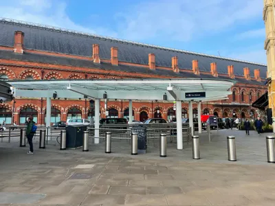 A station taxi rank ('Taxi Queue') — join this line instead of going with anyone who approaches you