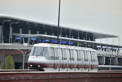 AirTrain Newark running past the new Terminal A at Newark Liberty