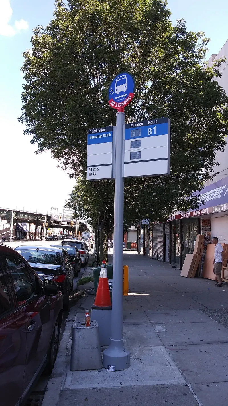 The round blue sign marks the bus stop; at this one, the panel below shows the route number (B1) and destination