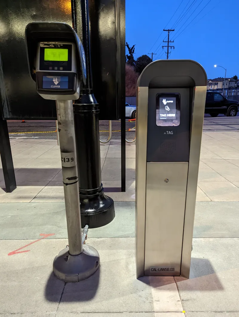 Clipper readers standing on a Caltrain platform — two different models side by side (Lawrence station)