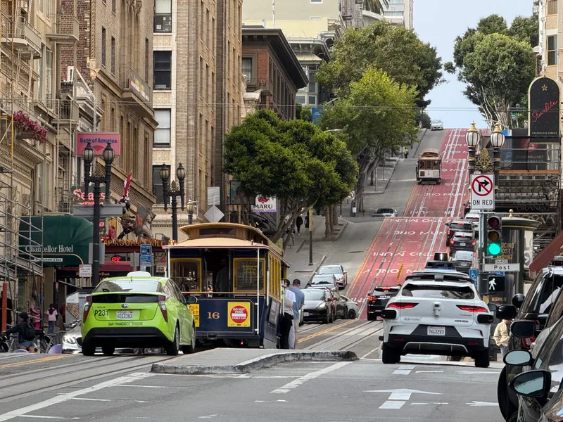 Cable car No. 16 on Powell Street, with another cable car on the hill beyond
